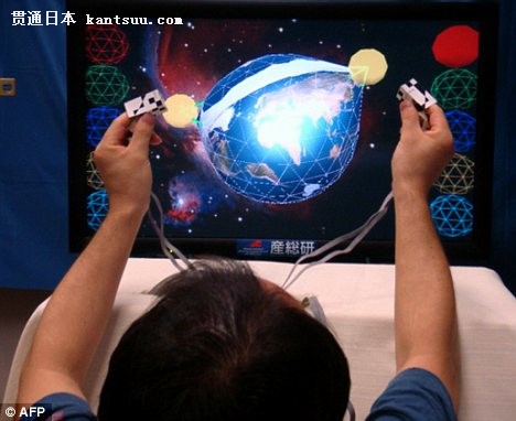 A member of the Japanese research team demonstrates the world's first 3D TV that allows users to touch, pinch or poke images that appear to float in front of them